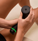 Close-up of the Hypervolt 3 massage gun on the thigh