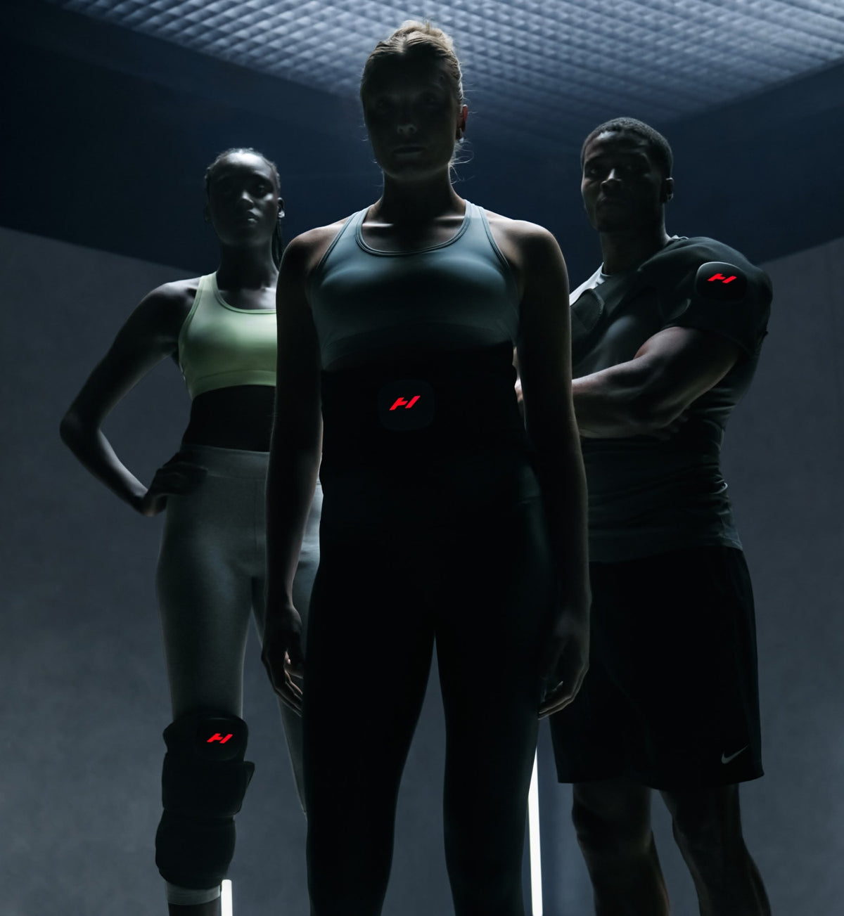 Three athletes in athletic wear wearing a venom 2 back, a venom 2 leg, and a venom 2 shoulder
