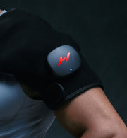 close up of a person wearing the venom 2 shoulder on a dark background